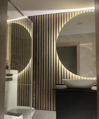 a bathroom with a sink and a mirror at LUX Apartamentai in Marijampolė