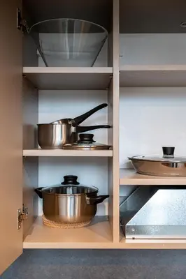 a kitchen with two pots and pans on shelves at Brand New Urban Lofts by Reside Baltic in Vilnius