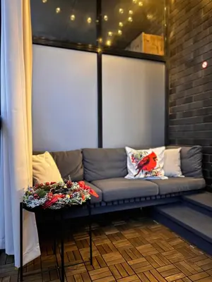 a couch sitting in a room with a window at Parko rezidencija apartments II - SELF CHECK-IN in Panevėžys