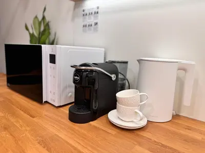 a coffee maker and a coffee cup on a counter at Parko rezidencija apartments II - SELF CHECK-IN in Panevėžys
