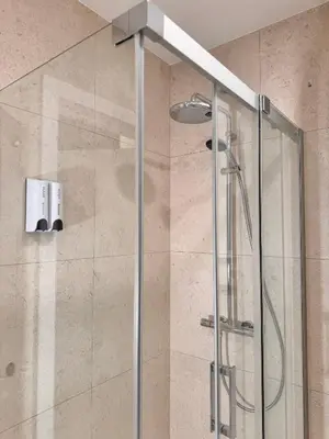 a shower with a glass door in a bathroom at Parko rezidencija apartments II - SELF CHECK-IN in Panevėžys