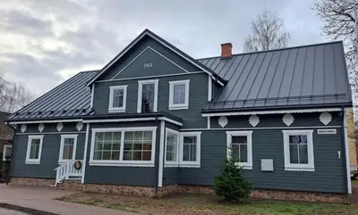 a black house with a gray roof at Stebuklėlis in Pakruojis
