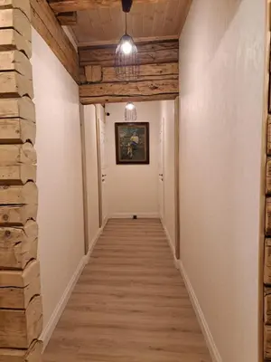 a hallway with wood floors and a ceiling at Stebuklėlis in Pakruojis