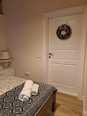 a bedroom with a bed with two towels on it at Stebuklėlis in Pakruojis