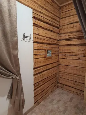 a corner of a room with wooden walls at Stebuklėlis in Pakruojis