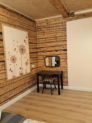 a room with a table and a mirror on a wall at Stebuklėlis in Pakruojis