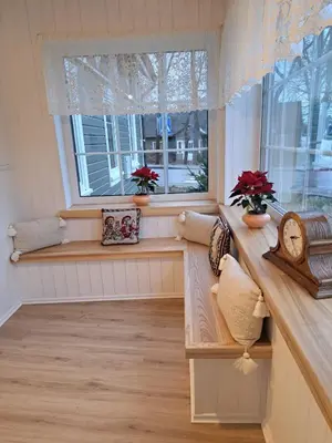 a room with a window with a bench and flowers at Stebuklėlis in Pakruojis