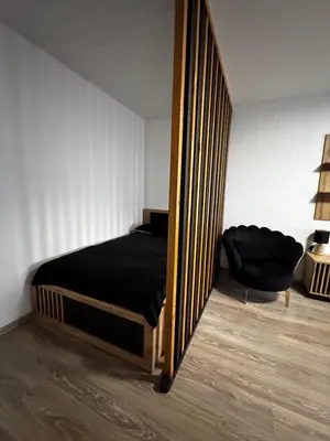 a bedroom with a bed and a large mirror at Gold & Black in Kėdainiai