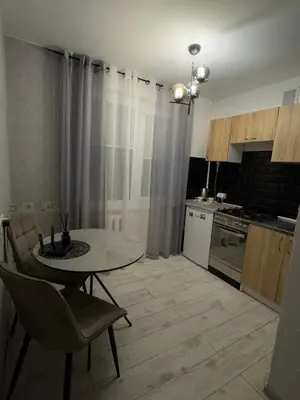 a kitchen with a table and chairs in a room at Gold & Black in Kėdainiai