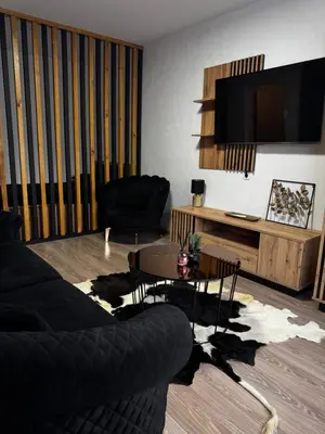 a living room with a couch and a table at Gold & Black in Kėdainiai