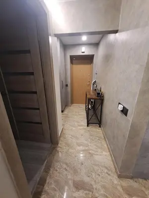 a hallway with a door and a table in a room at Kėdainiai Alinos Apartamentai in Kėdainiai