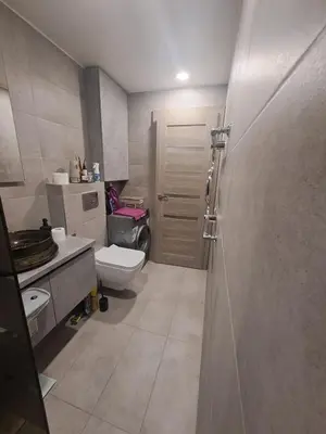a bathroom with a toilet and a sink and a shower at Kėdainiai Alinos Apartamentai in Kėdainiai