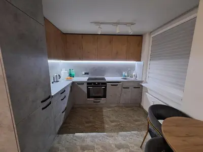 a small kitchen with a sink and a stove at Kėdainiai Alinos Apartamentai in Kėdainiai