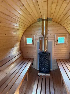 an inside view of a sauna with two benches at Poilsio oazė Stebuliuose in Stebuliai
