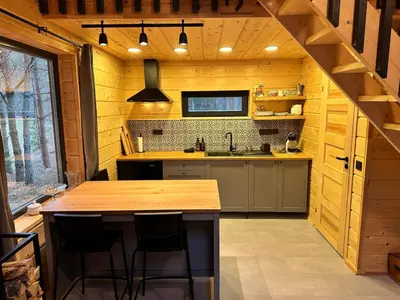 a kitchen with wooden walls and a wooden counter top at Local Forest in Vilnius