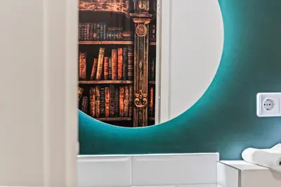 a room with a book shelf filled with books at Blue Oasis and Wizard's Hideaway apartments in Kaunas