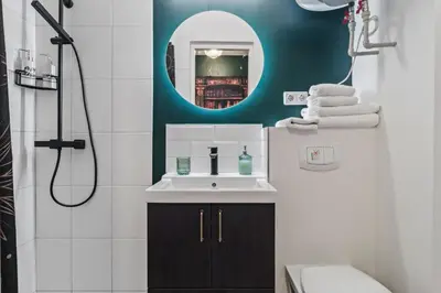 a bathroom with a sink and a mirror at Blue Oasis and Wizard's Hideaway apartments in Kaunas