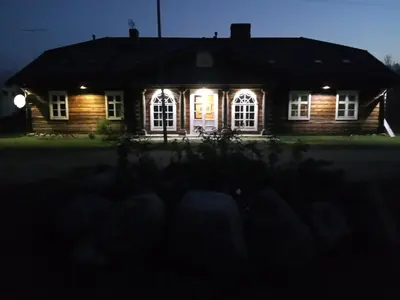a house with lights on the front at night at Senosios Gegužinės ūkis in Gegužinė
