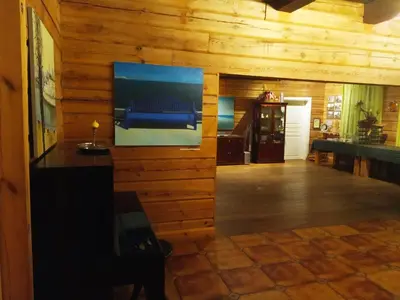 a living room with a television on a wooden wall at Senosios Gegužinės ūkis in Gegužinė