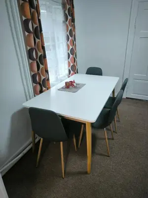 a white table and chairs in a room at Kambarių nuoma 
