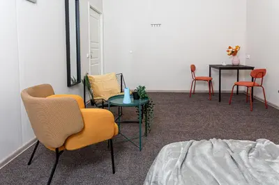 a room with chairs and a table and a bed at Urban Style Old Town in Kaunas