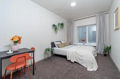 a bedroom with a bed and a desk and a window at Urban Style Old Town in Kaunas