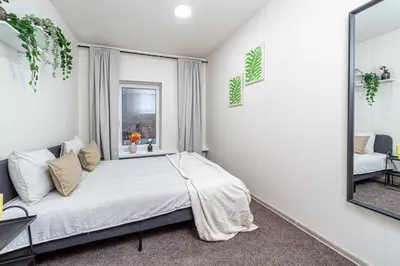 a bedroom with a bed and a mirror at Urban Style Old Town in Kaunas
