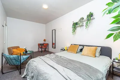 a bedroom with a bed and a table and chairs at Urban Style Old Town in Kaunas
