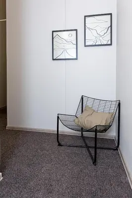 a chair in a room with two pictures on the wall at Urban Style Old Town in Kaunas