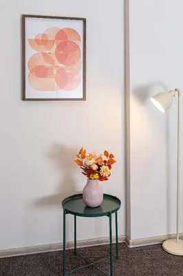 a vase with flowers on a table in a room at Urban Style Old Town in Kaunas