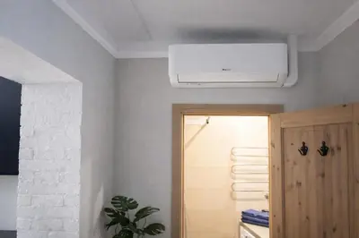 a ceiling fan in a room with a door at Downtown Apartment Rentals in Šiauliai