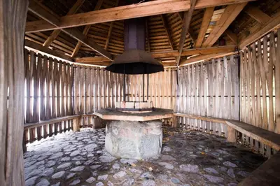 a room with a table and an umbrella in it at Pakaso sodyba in Kirdeikiai