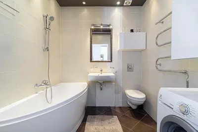 a bathroom with a tub and a toilet and a sink at Cute apartment Konstitucijos ave in Vilnius
