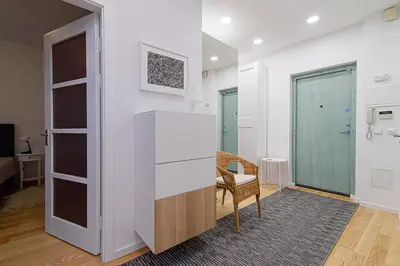 a room with a desk and a chair and a closet at Cute apartment Konstitucijos ave in Vilnius