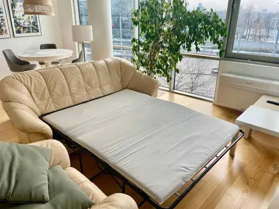 a coffee table in a living room with a couch at Cute apartment Konstitucijos ave in Vilnius