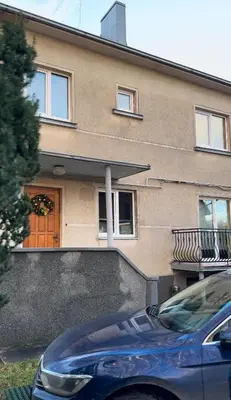 a house with a car parked in front of it at Park Hostel in Šiauliai