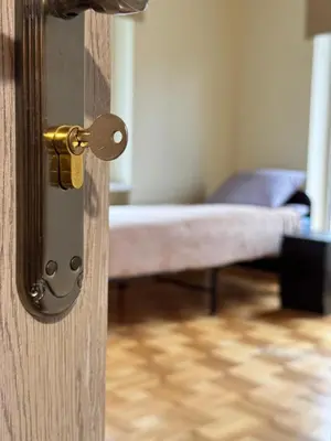 an open door to a bedroom with a bed at Park Hostel in Šiauliai