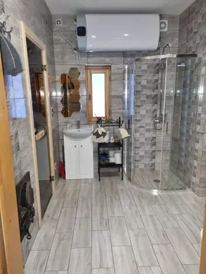 a bathroom with a shower and a sink at Ramaus poilsio sodyba in Petruniškis