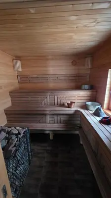 a sauna with a bench in a wooden room at Ramaus poilsio sodyba in Petruniškis