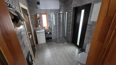 a bathroom with a shower and a sink at Ramaus poilsio sodyba in Petruniškis
