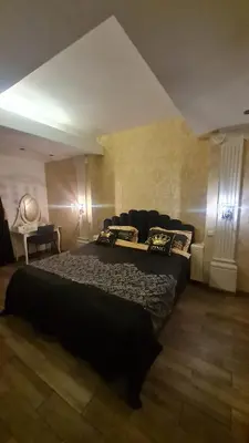 a bedroom with a large bed and a couch at Apartamentai su jacuzzi in Vilnius