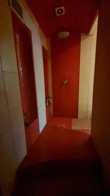 an empty bathroom with a shower in a room at Apartamentai su jacuzzi in Vilnius