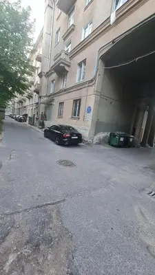 a car parked next to a building with a garage at Apartamentai su jacuzzi in Vilnius