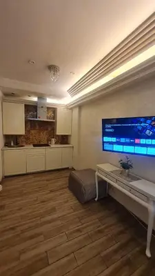 a living room with a large monitor on the wall at Apartamentai su jacuzzi in Vilnius