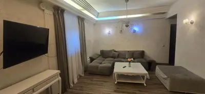 a living room with a couch and a table at Apartamentai su jacuzzi in Vilnius