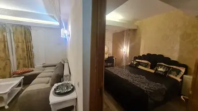 a room with a bed and a couch in it at Apartamentai su jacuzzi in Vilnius