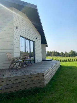 a deck with a table and chairs on the side of a house at Sauna for celebration and leisure in Grygaytse