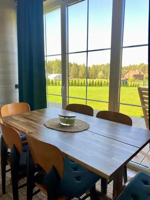 a wooden table with chairs and a bowl on top at Sauna for celebration and leisure in Grygaytse