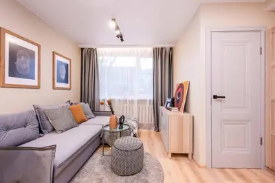 a living room with a couch and a window at Cozy flat in Antakalnis in Vilnius
