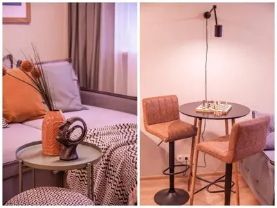 a room with a table and a chair and a bed at Cozy flat in Antakalnis in Vilnius